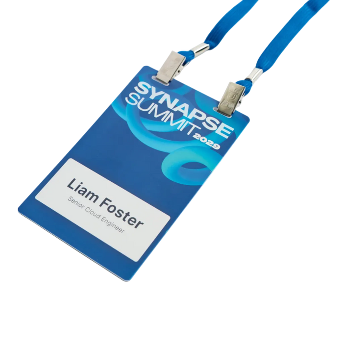 Blue plastic name badge lying diagonally with its double-clip lanyard open
